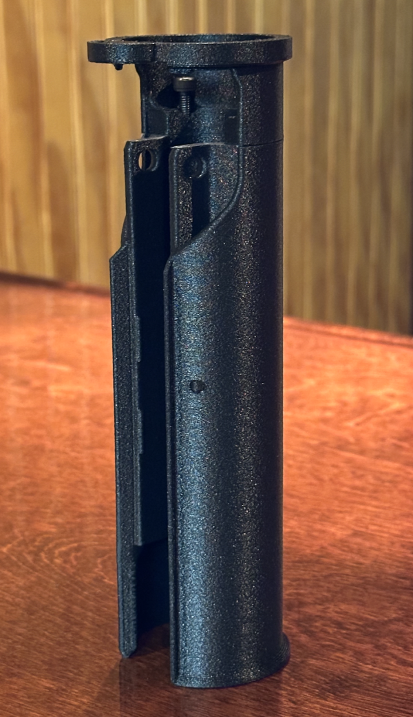 A picture of the BL-SD Handguard Adapter placed vertically on a table.